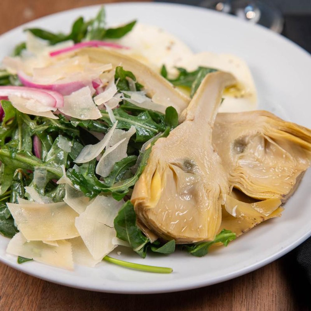 Arugula Artichoke Salad With Mozzarella Shaved Parmesan And Red Onions.