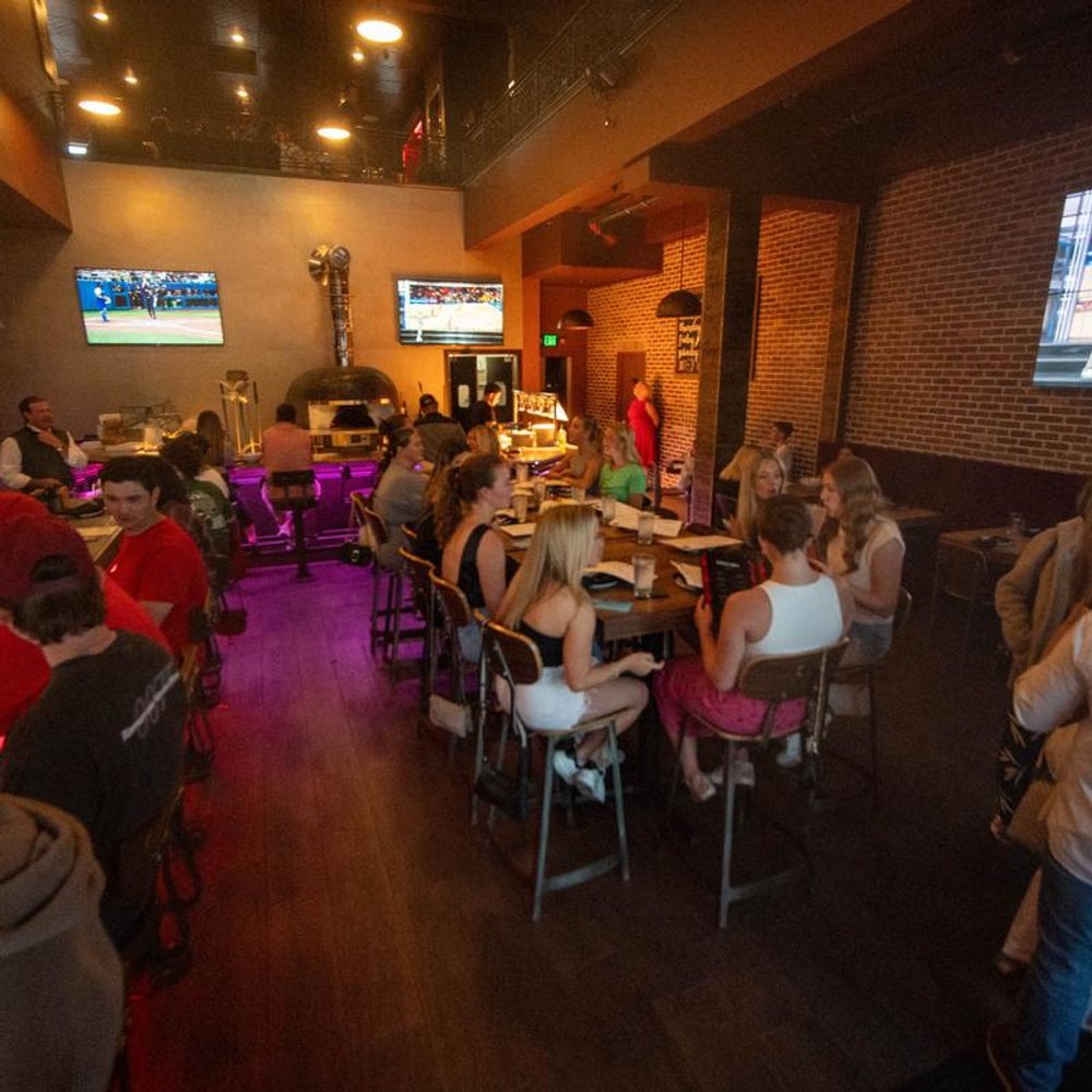 Bar Interior Guests Seated At Tables Tvs.