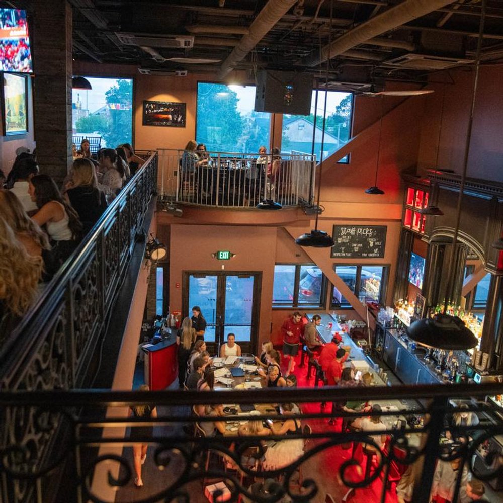Bar Interior With Guests Seated Both On Mezzanine And Ground Floor.