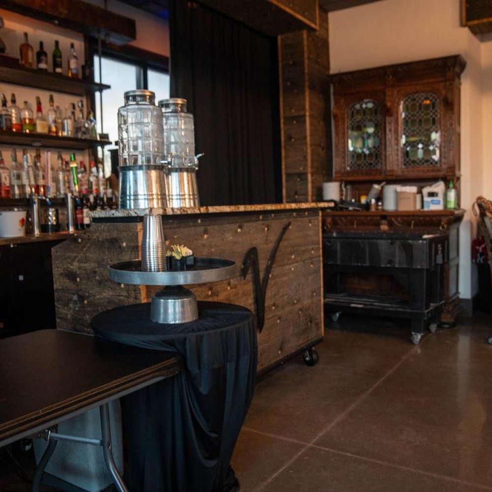 Bar With A Cabinet Shelves Of Liquor And Beverage Dispensers On A Counter.