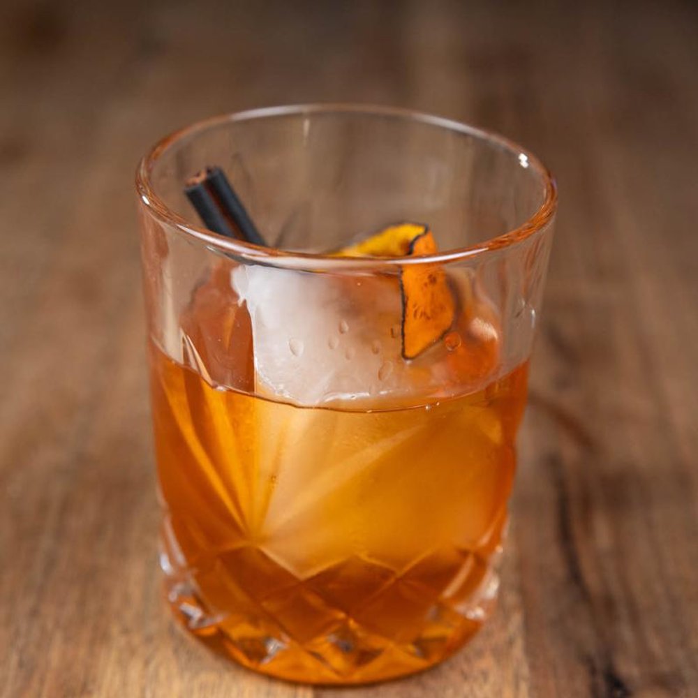 Bulleit Proof Cocktail Garnished With A Burnt Orange Peel.