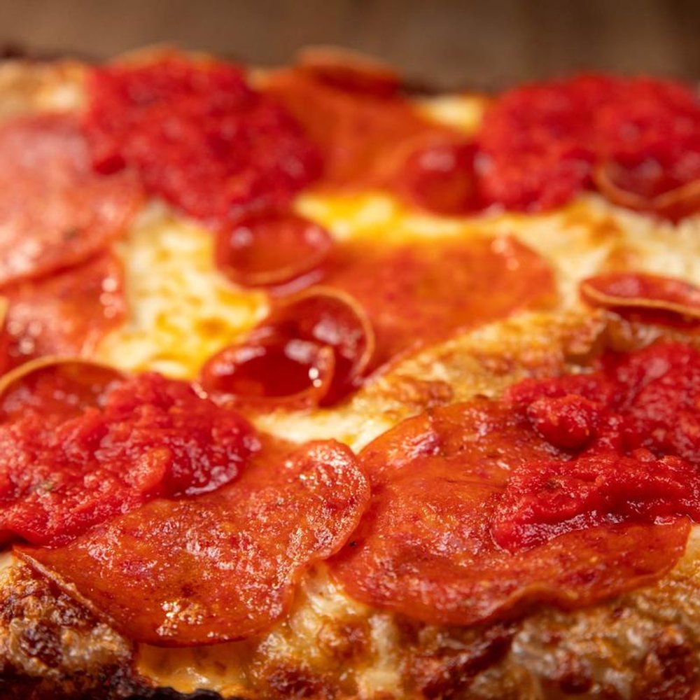 Close Up Of A Pepperoni Pizza With Melted Cheese.