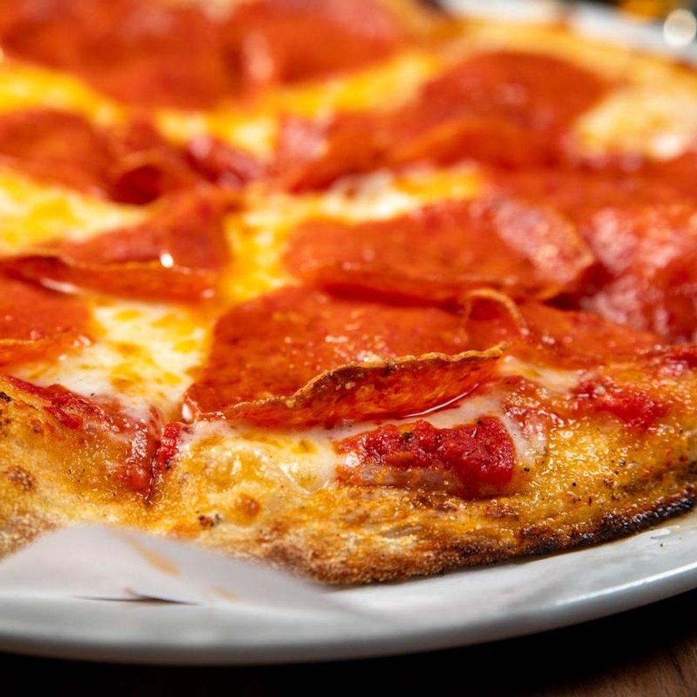 Close Up Of A Pepperoni Pizza With Mozzarella And Red Sauce.