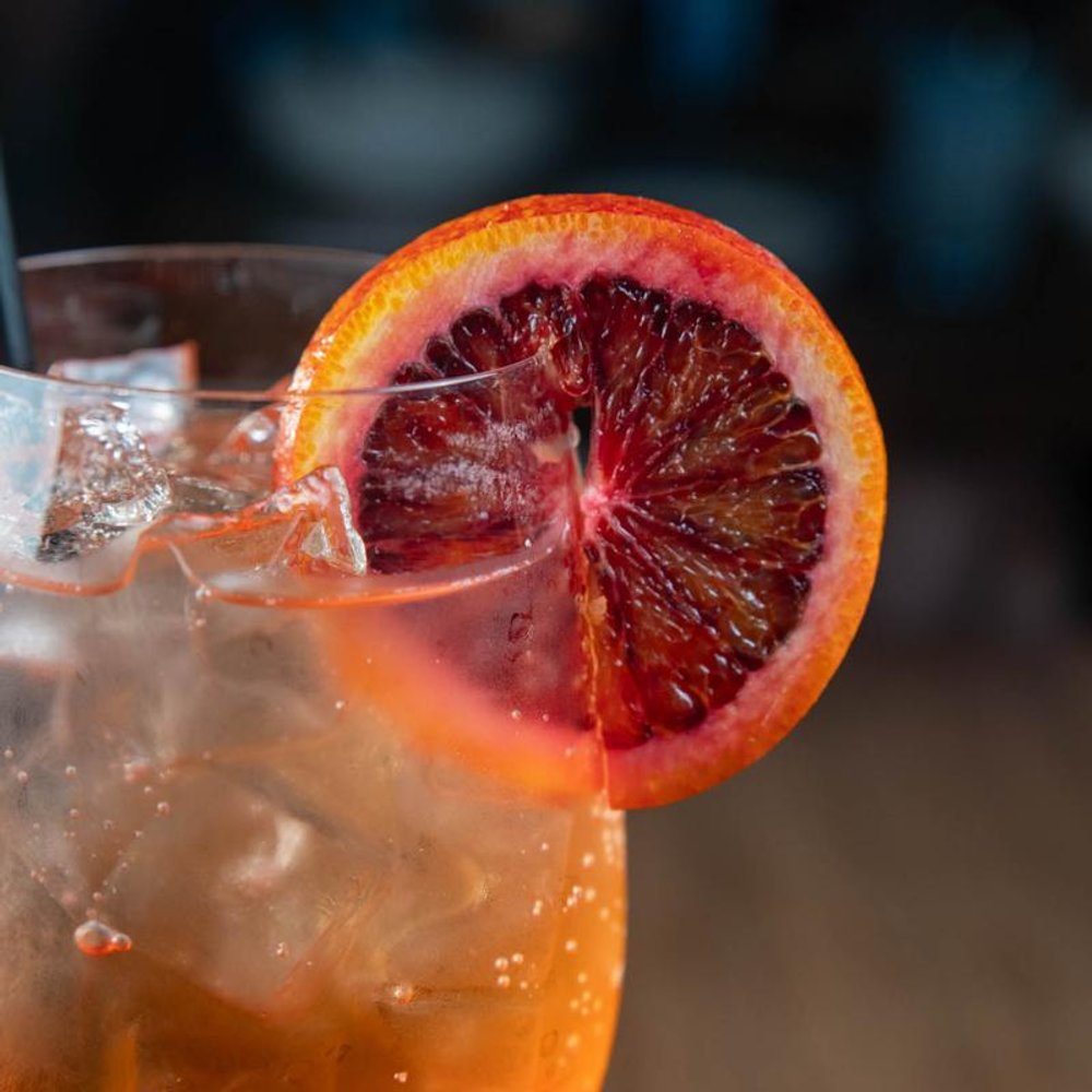 Close Up Of The Aperol Spritz Garnished With A Slice Of Blood Orange.