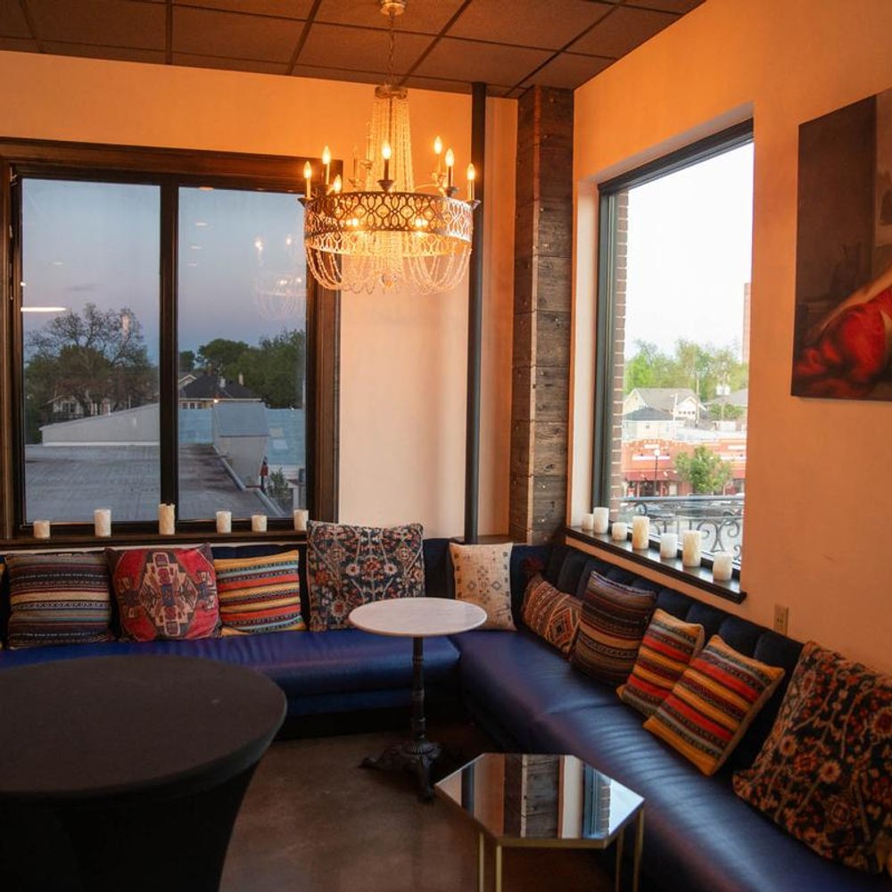 Corner Seating Area By The Windows With Benches Pillows And Tables.