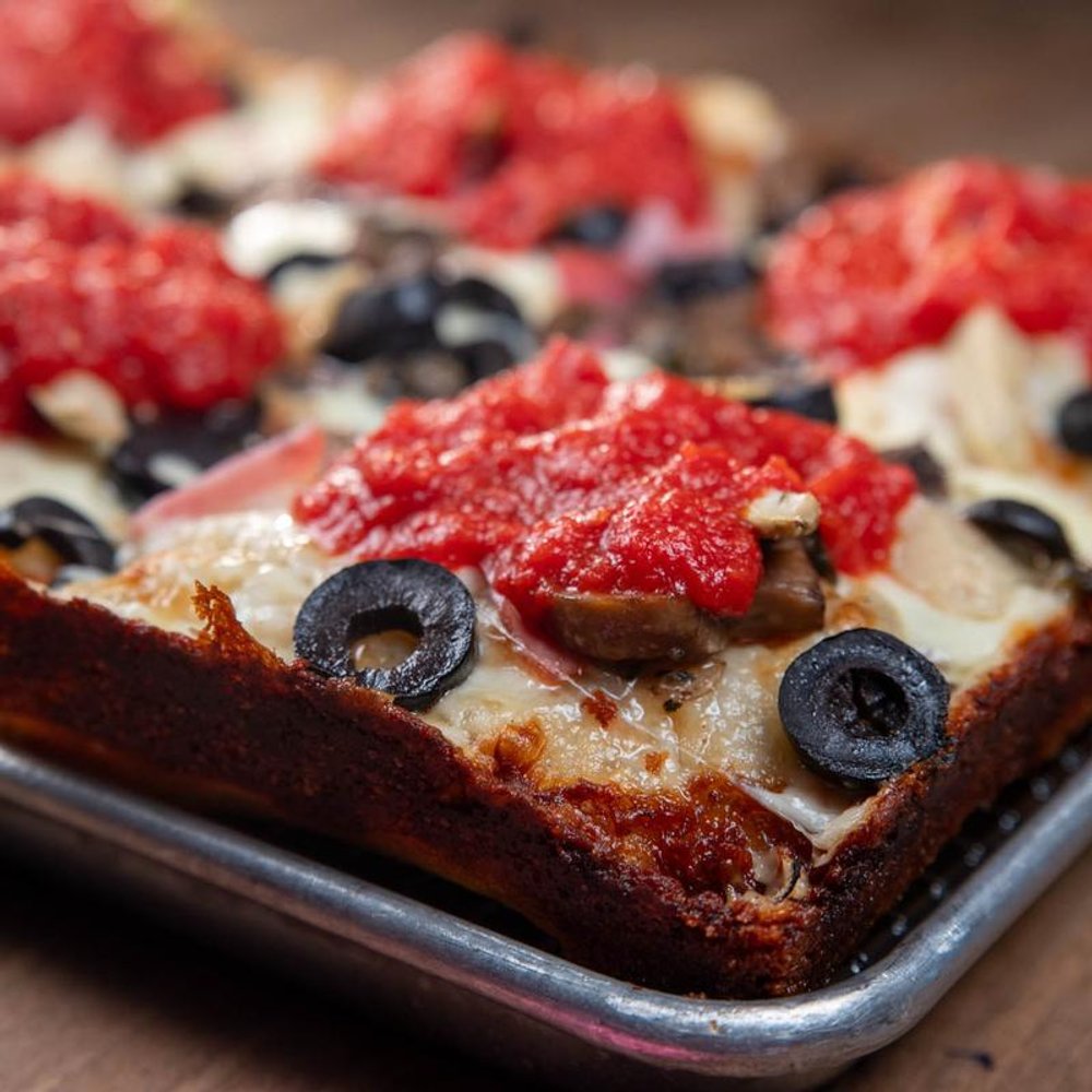 Detroit Style Pizza With Cheese Tomato Sauce Olives And Ham.