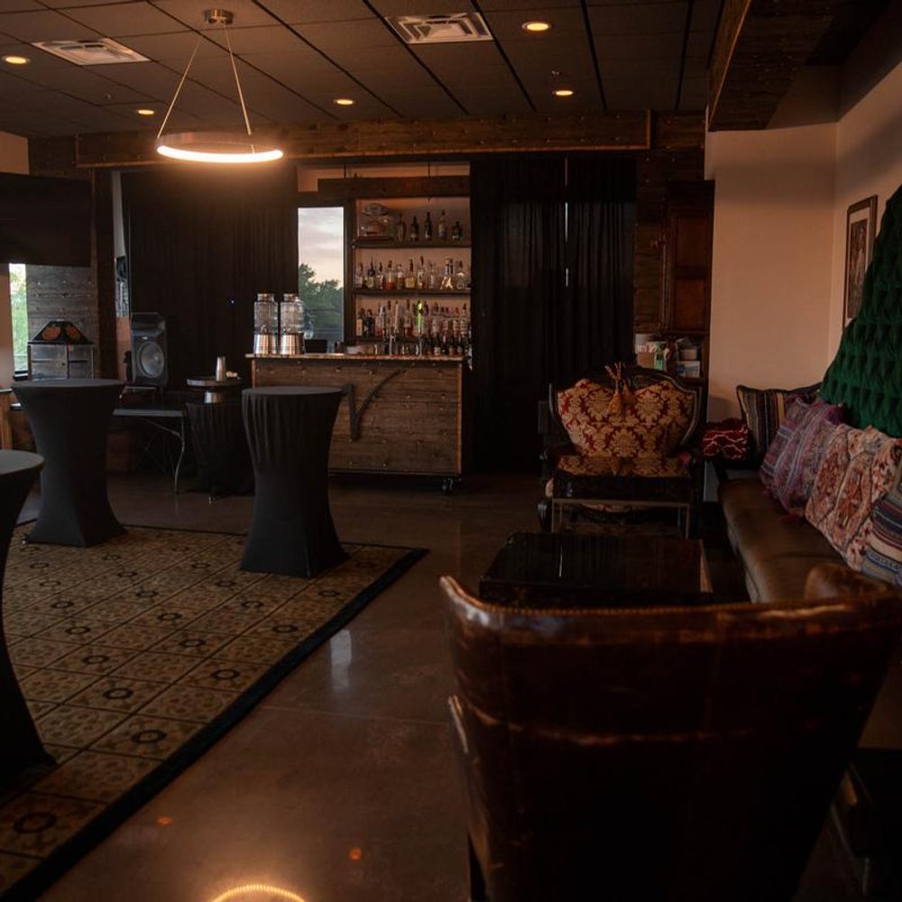 Interior With A Bar Lounge Seating And Cocktail Tables.