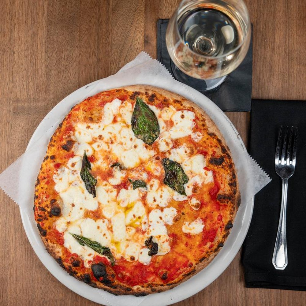 Margherita Pizza Served With A Glass Of White Wine.