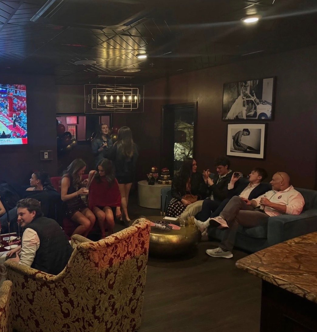 Lounge area with a bar sofas guests and TVs