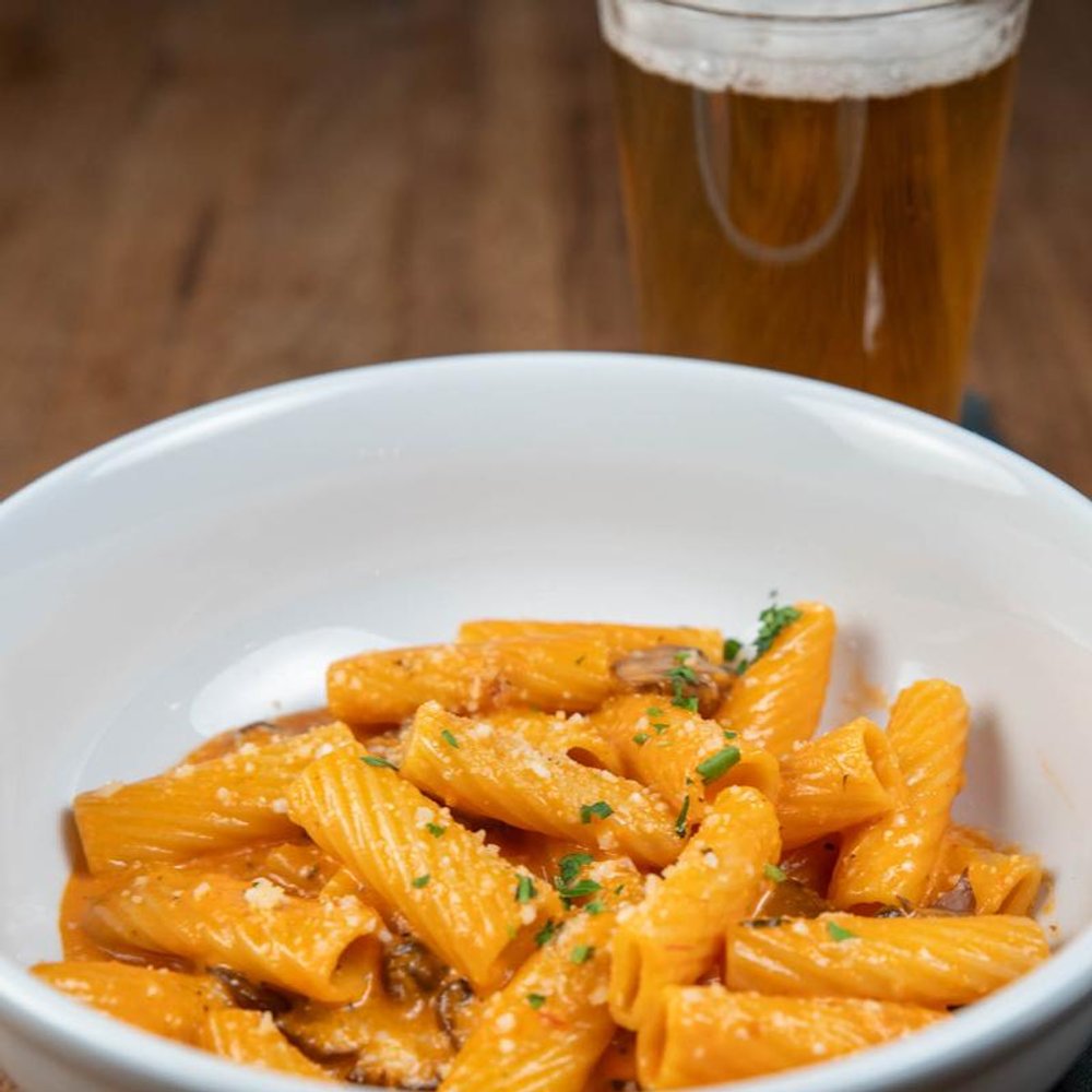 Mushroom Rigatoni With Parmesan Cheese And Tomato Cream Sauce.