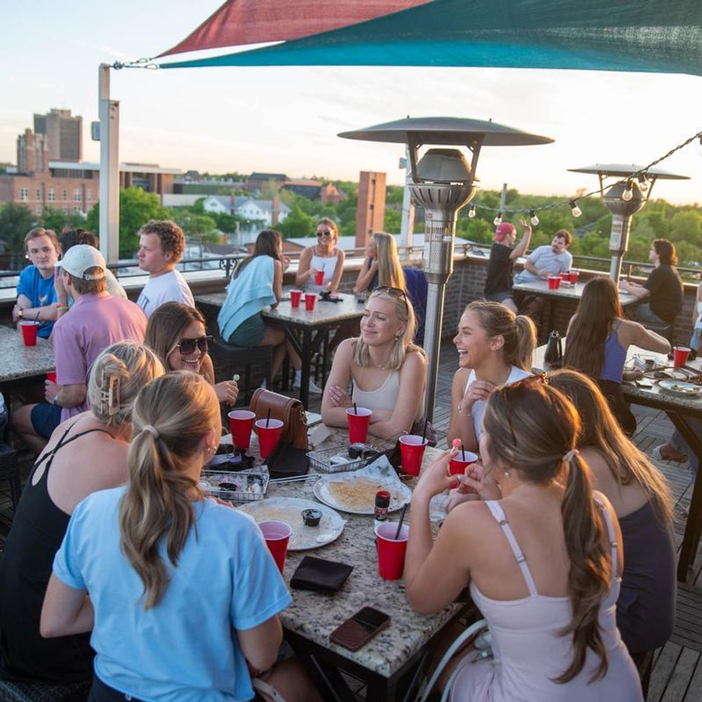 People Having Drinks On A Bar Terrace With A Nice View.