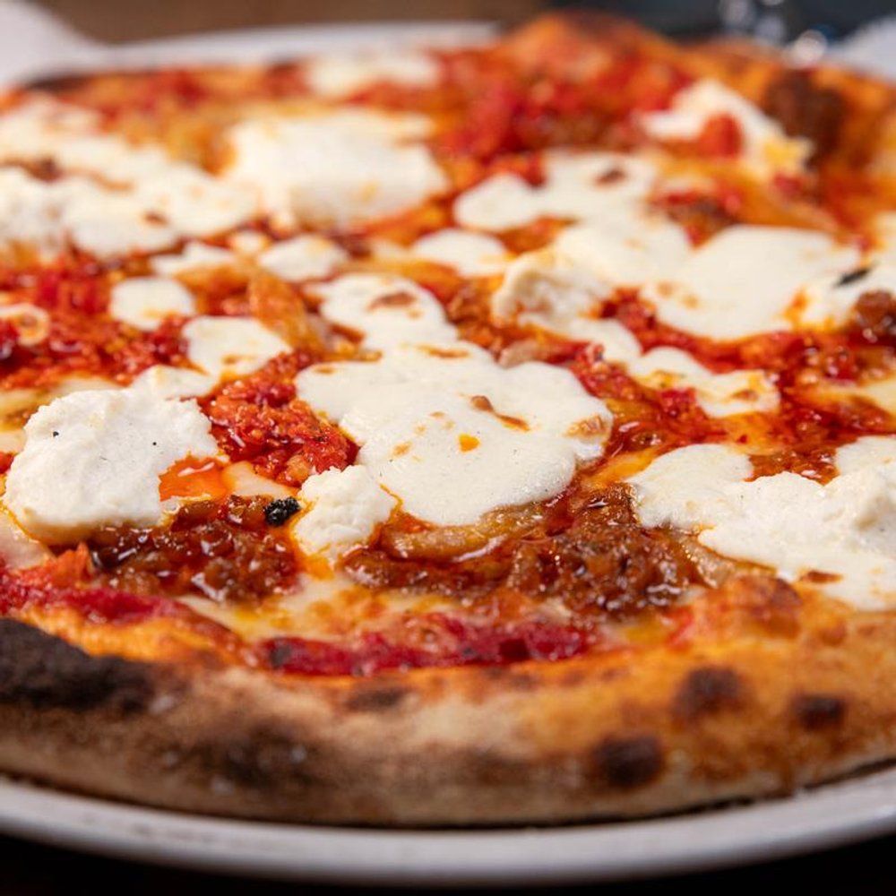 Pizza Topped With Ricotta Mozzarella Parmesan Italian Sausage And Caramelized Fennel.