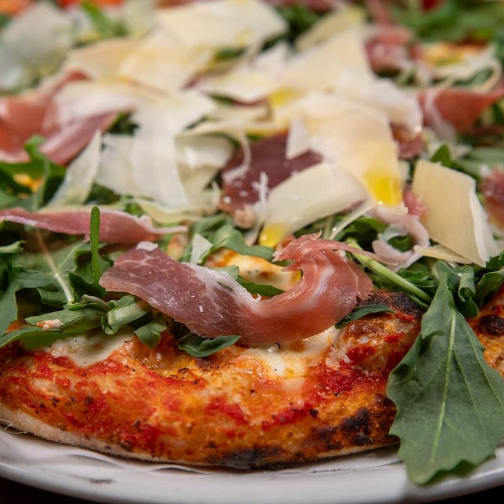 Prosciutto Arugula Pizza With Parmesan Close Up.