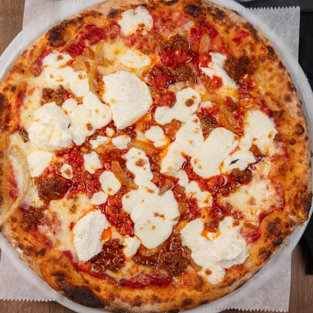 Red Pizza With Sausage Ricotta Mozzarella Parmesan And Caramelized Fennel.