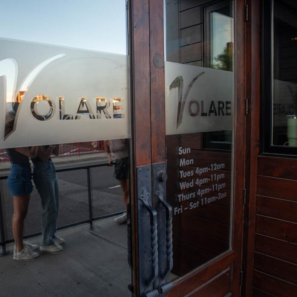 Restaurant Entrance Door With Business Name On Frosted Vinyl Opening Hours Just Below It.