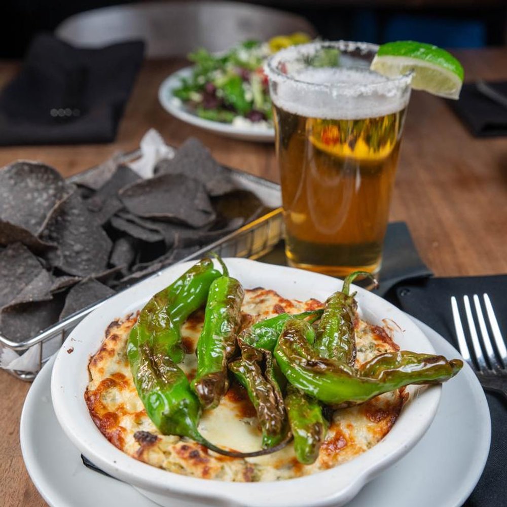 Roasted Shishito Peppers Served With Blue Corn Tortilla Chips And A Glass Of Beer.