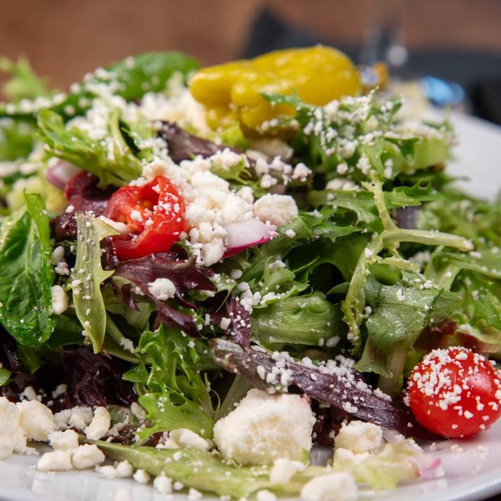 Salad With Mixed Greens Tomatoes Feta And Onion Close Up.