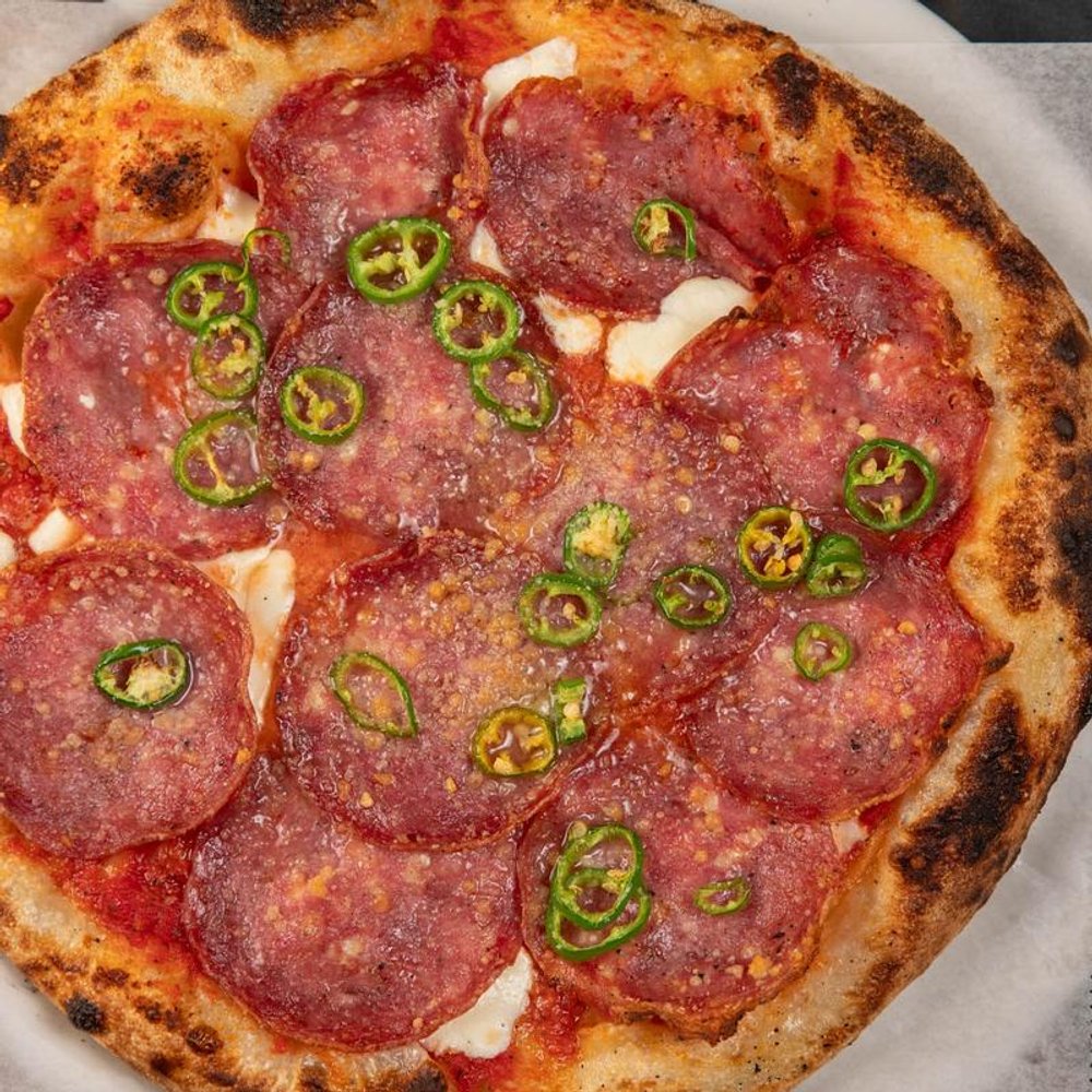 Soppressata Pizza With Mozzarella Parmesan Red Sauce And Serrano Peppers.