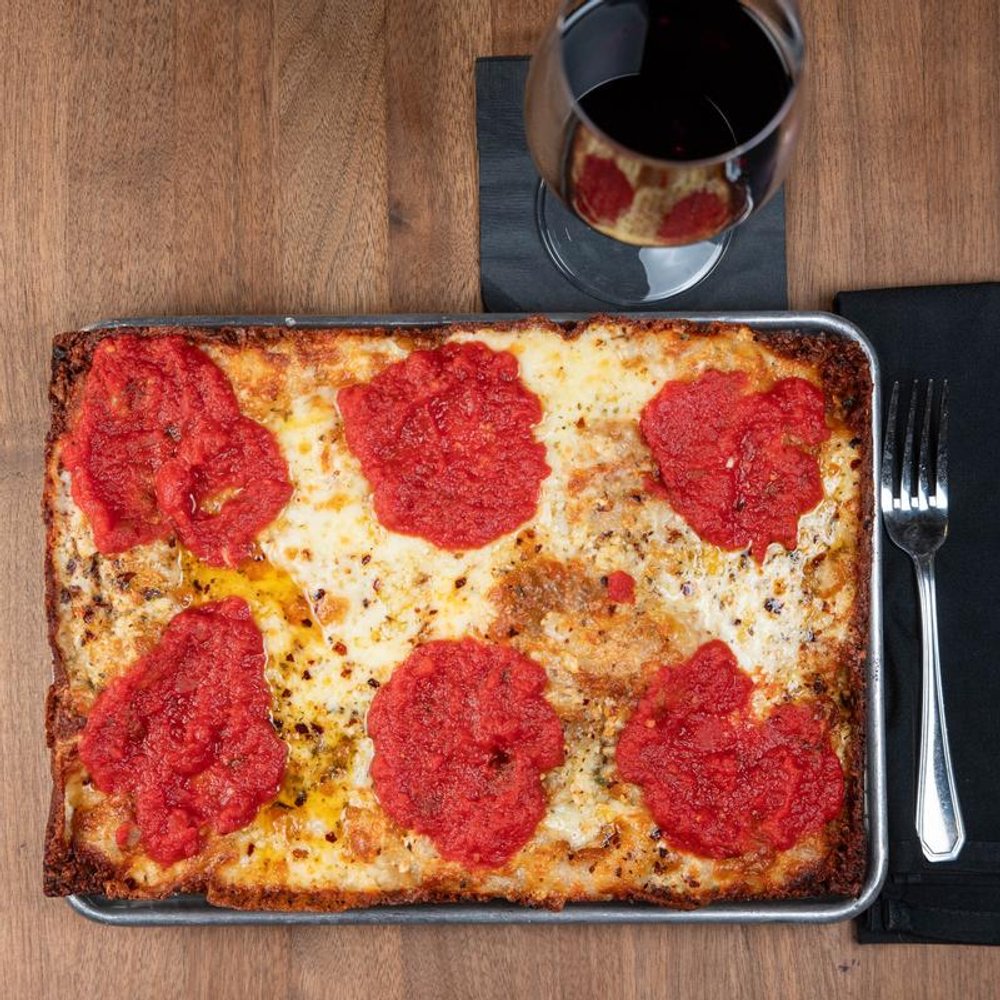 Square Cheese Pizza With Tomato Basil Sauce Crushed Red Peppers And Oregano.