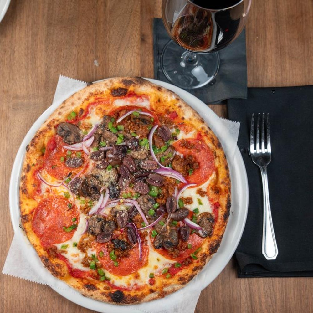 Supreme Pizza With Sausage Pepperoni Mozzarella Green Peppers And Olives.